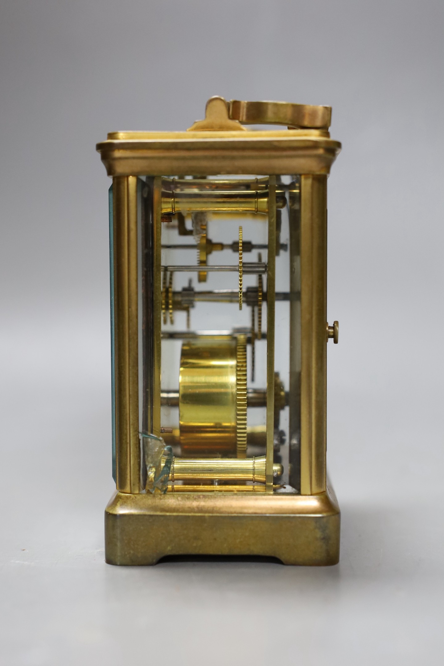 A leather cased brass carriage timepiece. 13cm tall